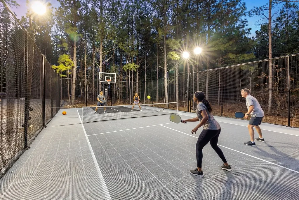 Guests playing pickleball on the lighted private sport court at LivNLove cabin