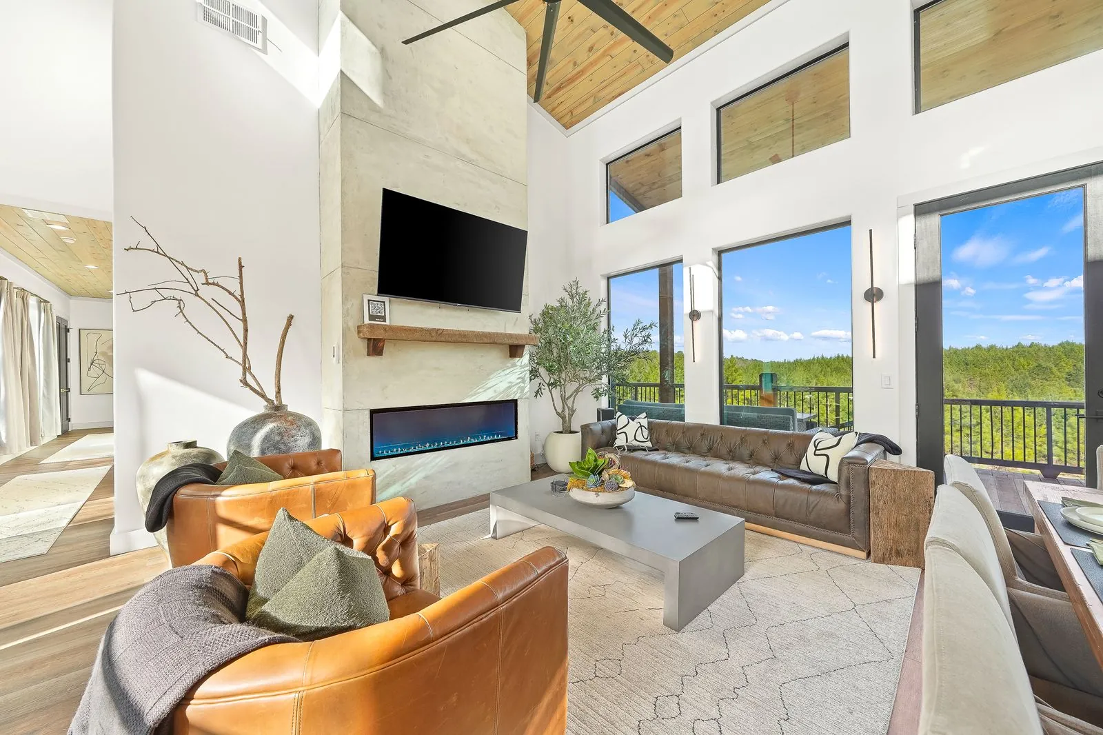 Covered upper deck at The Malibu with outdoor sectional sofa overlooking the pool and pine tree canopy