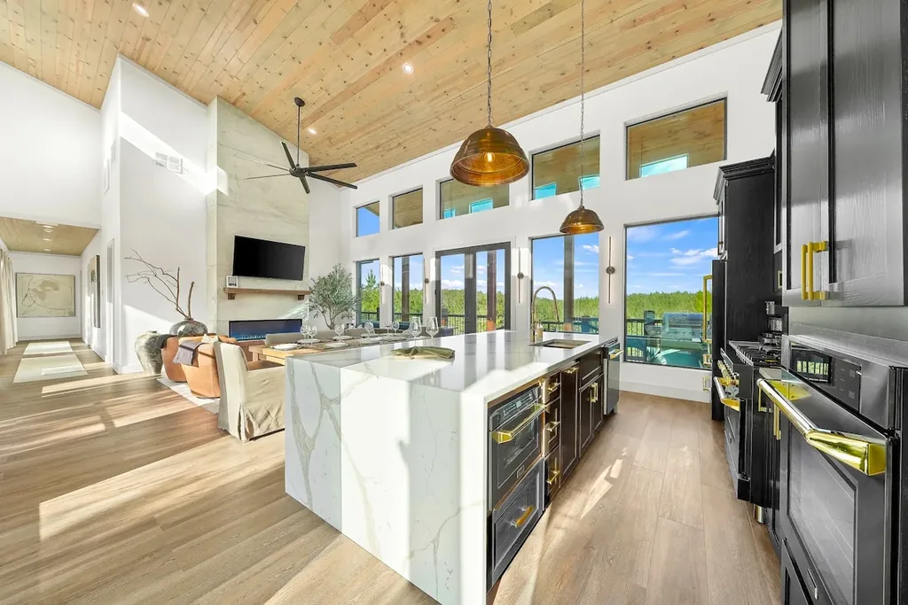 Wide open kitchen with marble island looking toward the living room