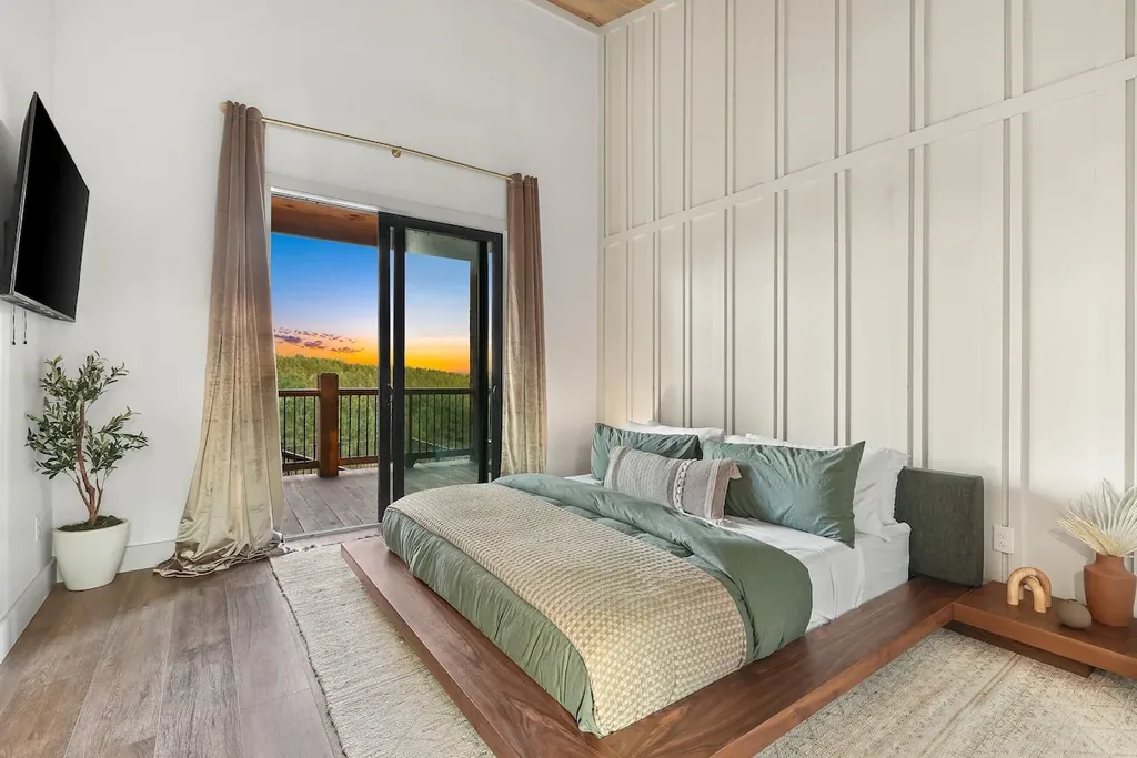 King Bedroom 4 with green bedding and private balcony doors