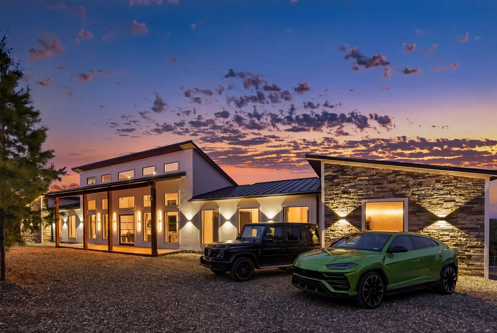 Exterior of The Malibu at dusk with driveway parking and warm lighting