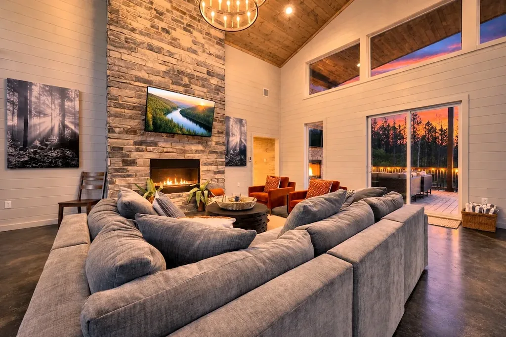 Miko Chukka — Gather around the stone fireplace on the oversized sectional with direct access to the private deck and evening views.