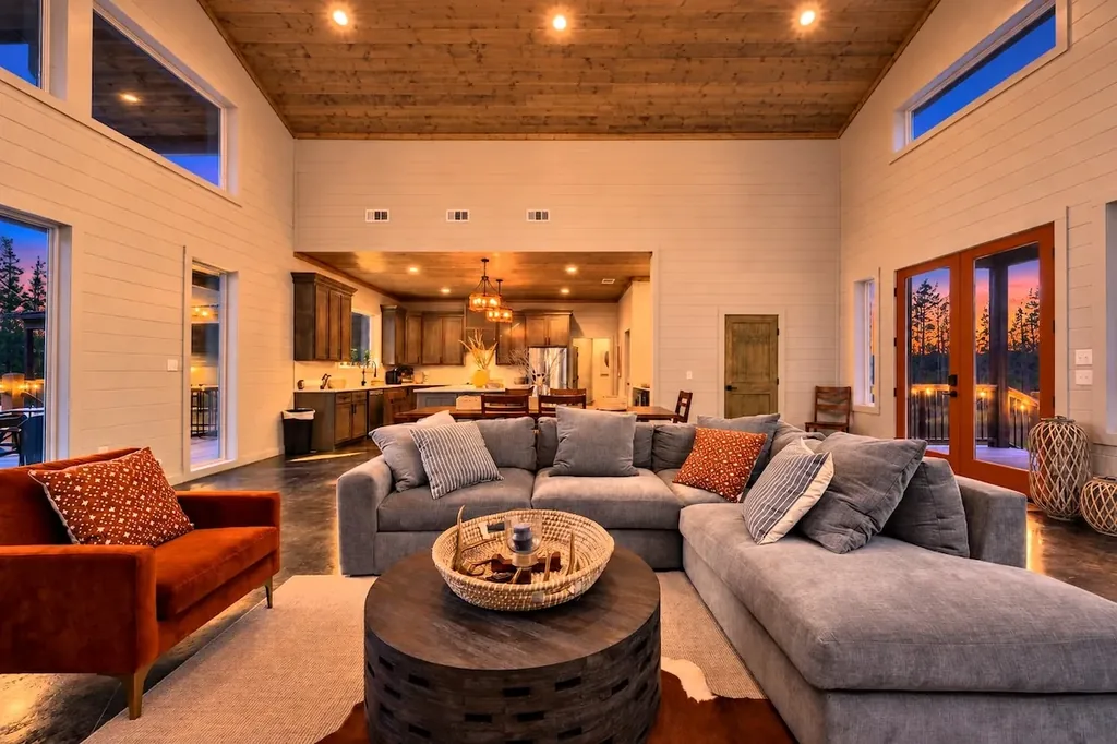 Miko Chukka — Gather the whole group on the oversized sectional beneath soaring wood-beamed ceilings, with the kitchen and dining space just steps away.