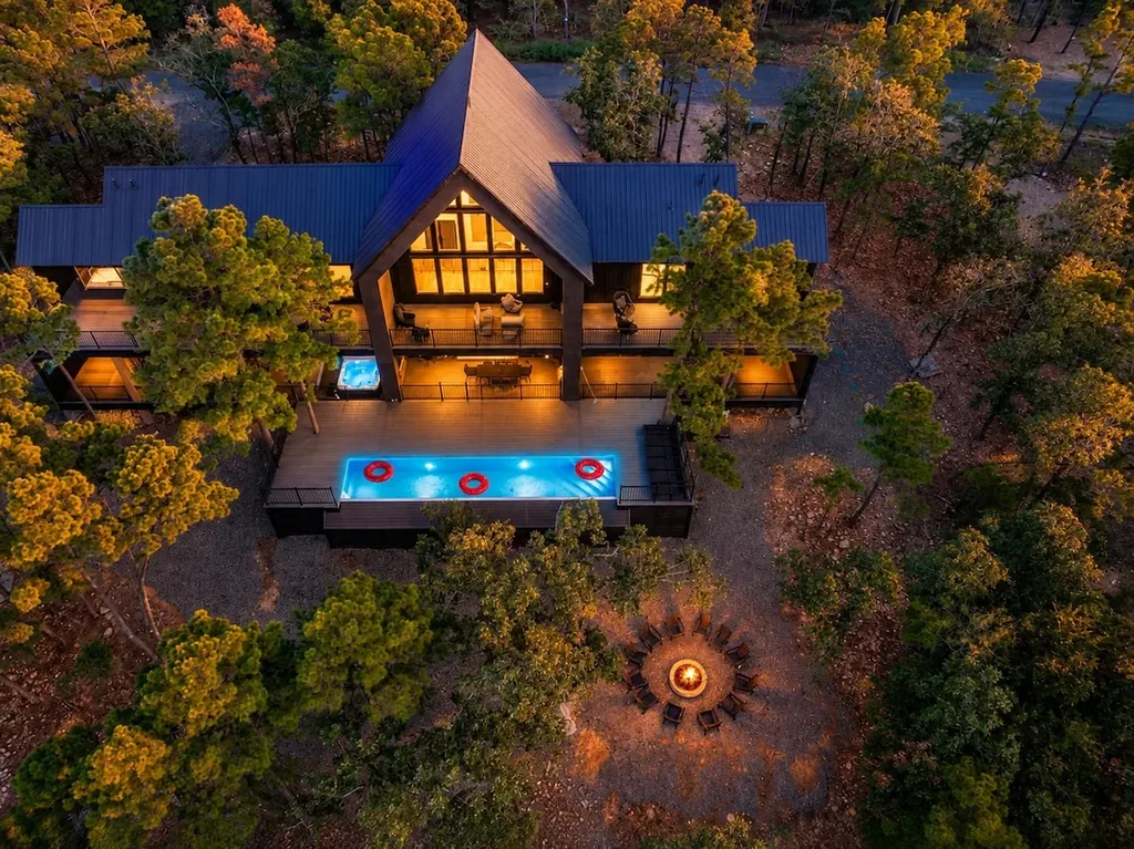 Sanctuary at the Summit — This treetop aerial view captures a private pool, hot tub, and fire pit, all steps from the cabin's own deck.